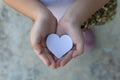Children hands holding small model of heart and family Royalty Free Stock Photo