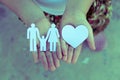 Children hands holding small model of heart and family Royalty Free Stock Photo