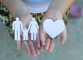 Children hands holding small model of heart and family Royalty Free Stock Photo