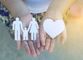 Children hands holding small model of heart and family Royalty Free Stock Photo