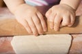 Children hands kneading dough Royalty Free Stock Photo