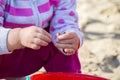 Hands of a little girl with sand