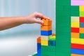 Children hands play with colorful plastic toys blocks on table Royalty Free Stock Photo