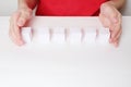 Children hands and row of six small paper cubes