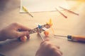 Children hands with Toy iron plane. Metal constructor with screwdrivers. Dream, play and create Royalty Free Stock Photo