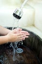 Children hands washing under outdoor tap water