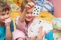 Children happily pull the card from card fan