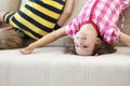 Children have fun at home, kids upside down on sofa, holiday at school