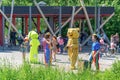 Children have fun in the park. Green rabbit Animator and bear winnie the pooh Animator hare entertains children in the park on a