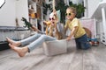 Children have fun and ride in a white plastic box. The room is a mess. Royalty Free Stock Photo