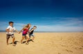 Children have fun run on the sand beach together Royalty Free Stock Photo