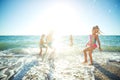 Children have fun on the sandy beach in summer. Royalty Free Stock Photo