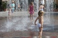 Children under fountain have fun with water refreshment in summer heat, Friedrichshafen, Germany Royalty Free Stock Photo