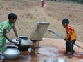 A Children have gathered in the hand pump for water