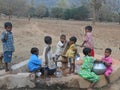 A Children have gathered in the hand pump for water