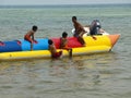 Children having fun with the banana boat at the beach Royalty Free Stock Photo