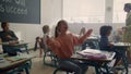 Children having fun in classroom. Mixed race pupils playing with paper planes Royalty Free Stock Photo