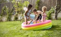 Children Having Fun In Garden Paddling Pool