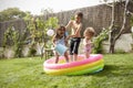 Children Having Fun In Garden Paddling Pool Royalty Free Stock Photo