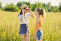 Children are having fun in nature, two girls laugh