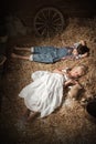 Children in the hay in the barn with a kitten