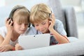 Children with headphones listening to music Royalty Free Stock Photo