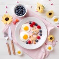 Children healthy breakfast eggs blueberries raspberries Beautiful table setting