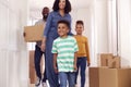 Children Helping Parents To Carry Boxes Into New Home On Moving In Day Royalty Free Stock Photo