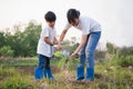 children helping planting tree in garden for save world. eco environment