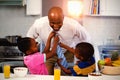 Children helping their father in tying tie