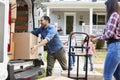 Children Helping Unload Boxes From Van On Family Moving In Day Royalty Free Stock Photo