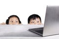 Children hiding behind white table