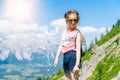 Children hiking on beautiful summer day in alps mountains Austria, resting on rock and admire amazing view to mountain Royalty Free Stock Photo