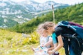 Children hiking on beautiful summer day in alps mountains Austria resting on rock. Kids look at map mountain peaks in Royalty Free Stock Photo