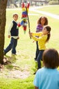 Children Hitting Pinata At Birthday Party Royalty Free Stock Photo