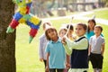 Children Hitting Pinata At Birthday Party