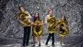 Children Hold Balloons In Form Of Numbers Two Thousand Twenty Three. One Boy Sprinkles Children With Sequins. New Year.