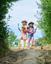 Children hold gardening tools. Working with plants is great pleasure. spring country side. small girls farmer in village