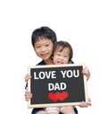 Children holding chalkboard with text Love you dad Royalty Free Stock Photo