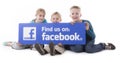 Children holding Facebook find us sign Royalty Free Stock Photo