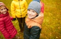 Children holding hands and playing in autumn park Royalty Free Stock Photo