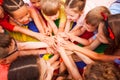 Children holding hands together, laying on a floor Royalty Free Stock Photo