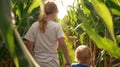 Children Holding Hands Walking Through Cornfield on a Sunny Day. Royalty Free Stock Photo