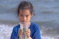 Children holding Plastic cup that he found on the beach for enviromental clean up concept