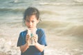 Children holding Plastic cup that he found on the beach for enviromental clean up concept