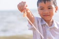 Children holding Plastic straw that he found on the beach for enviromental clean up concept