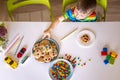 Funny male brothers eat cookies with round multi-colored sweets m&m and drink milk. Royalty Free Stock Photo