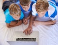 Children, home and playing on laptop in bedroom, care and excited for online videos in house. Young brothers, mousepad