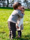 Children hug each other in the garden dressed casual Royalty Free Stock Photo