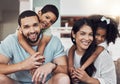 Children hug, home relax and parents with smile for happy house on the living room sofa together. Portrait of an African Royalty Free Stock Photo
